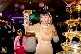 The bride reacts with surprise while taking the first glass from the Crémant fountain at Le Taennel in Scherwiller, France